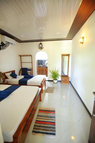 a bedroom with two beds in a room at Lisky villa Blue Beach Hiriketiy in Dickwella