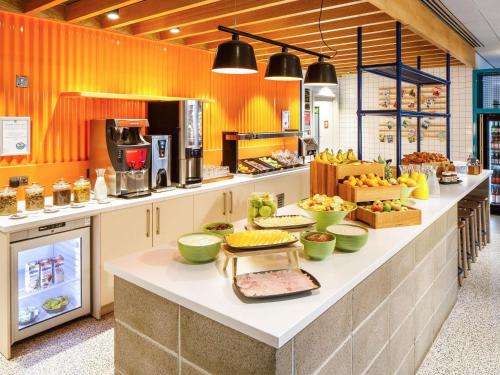 a kitchen with a counter with food on it at ibis budget Manchester Airport T2 in Hale