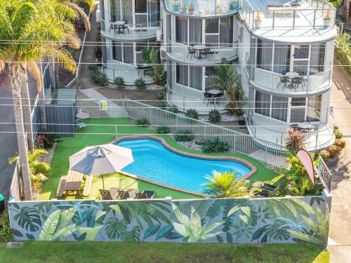 an aerial view of a building with a swimming pool at The Palms Apartments in Merimbula