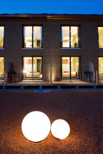 two lights in front of a building at night at Hotel Rovanada Wellness & BergNatur in Vals