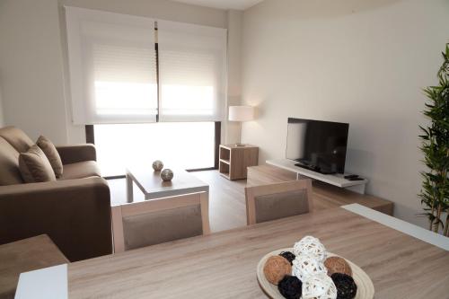 Телевизор и/или развлекательный центр в Apartamentos Pinar Malaga Centro