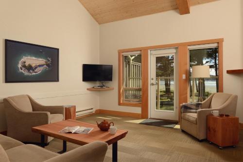 a living room with a couch and a table at Pacific Sands Beach Resort in Tofino