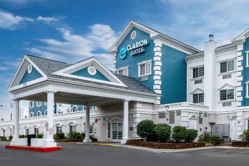 a large white building with a sign on it at Clarion Suites Anchorage Downtown in Anchorage