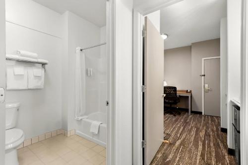 a bathroom with a toilet and a shower at Clarion Suites Anchorage Downtown in Anchorage