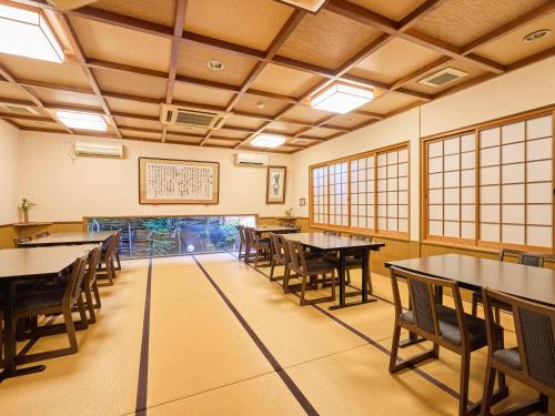 an empty dining room with tables and chairs at Oyado Yumechidori in Saga