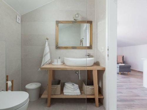 a bathroom with a sink and a mirror at Rustic Villa Nina Tucepi in Tučepi