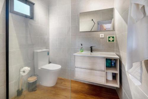 a bathroom with a toilet and a sink at Casa das Almas in Angra do Heroísmo