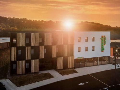 a rendering of a building with the sun behind it at Greet Hôtel Orthez Bearn in Orthez