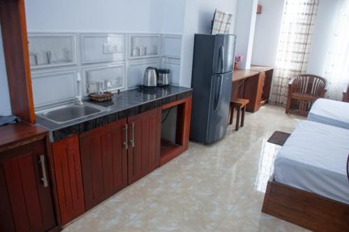 a kitchen with a black refrigerator and a sink at Apartment Room - Mathara in Matara