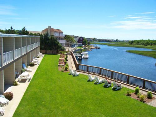 a balcony of a building with chairs and a river at Riverview Resort in South Yarmouth