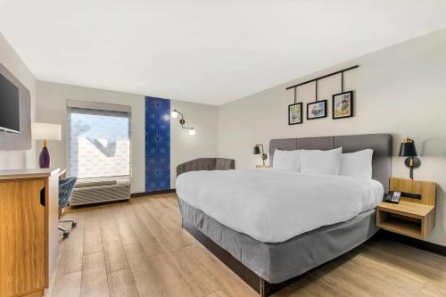 a hotel room with a large bed and a television at Sleep Inn in Manassas
