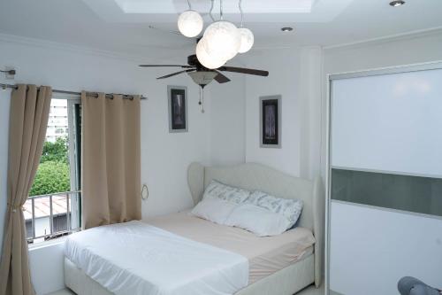 a bedroom with a bed and a ceiling fan at One Bedroom Condominium at Kandi Tower 2 in Angeles