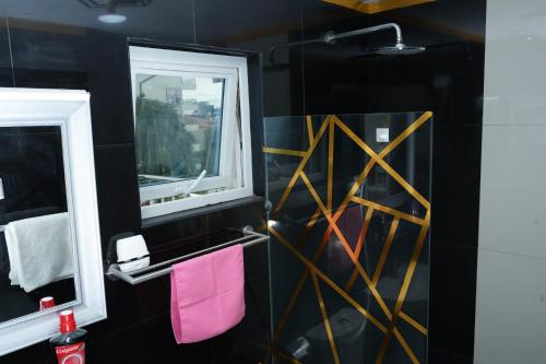 a bathroom with black walls and a mirror and pink towels at One Bedroom Condominium at Kandi Tower 2 in Angeles