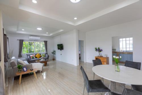 a living room with a table and a couch at ดารัดวัลเลย์ Darad Valley in Sara Buri