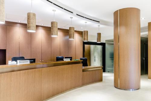 an office lobby with a reception desk and pendant lights at Hotel Reina Cristina in Teruel