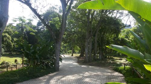a path in a park with trees and a sidewalk at Paraty Villa d`agua Temporada in Paraty