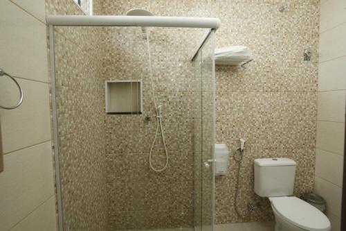 a bathroom with a glass shower with a toilet at Hotel Match Point in São Carlos