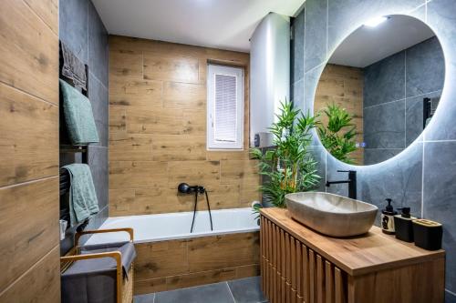 a bathroom with a tub and a sink at Luxury apartment with WiFi and Netflix Ostrava-Jih in Hrabŭvka