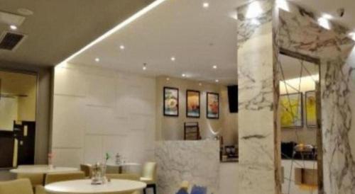 a bathroom with a sink and a mirror at Jinjiang Inn Wuhan Wujiashan Development District Branch in Wuhan