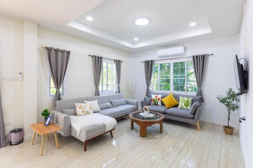 a living room with a couch and a table at ดารัดวัลเลย์ Darad Valley in Sara Buri