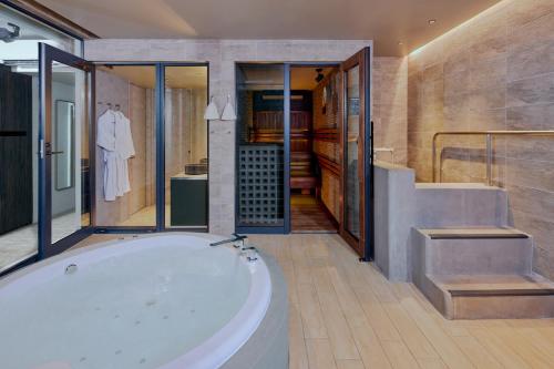 a large bathroom with a tub and a walk in shower at FAV LUX Nagasaki in Nagasaki
