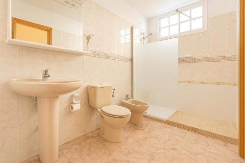 a bathroom with a sink and a toilet and a shower at Be six Playa La Arena in Puerto de Santiago