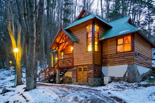 a log cabin in the woods in the snow at Aldea Nevada in Ushuaia