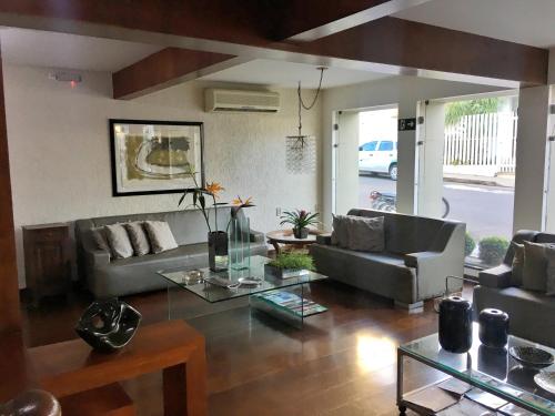 a living room with a couch and a table at Minas Palace Hotel in Passos