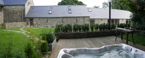 a bath tub in the yard of a house at Rhostwarch in Eglwyswrw