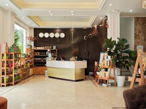 a store with a counter in the middle of a room at La Pense'e Hotel - Dalat in Da Lat