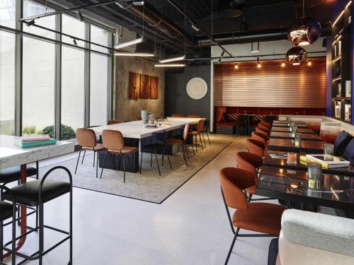 a dining room with a large table and chairs at Tribe Paris Saint Ouen in Saint-Ouen
