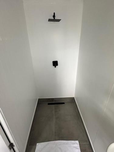 a white room with a speaker on the wall at Sundays River Adventures Tiny Homes in Gqeberha