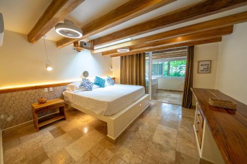 a bedroom with a large bed and a window at Dreamcatcher Hotel - Live the Dream of Santa Teresa in Santa Teresa Beach