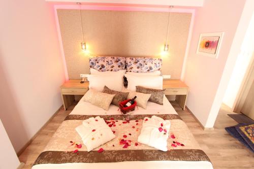a small bedroom with a bed with flowers on it at Hotel Mallas in Nea Kalikratia
