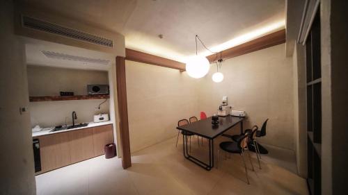 a kitchen with a table and chairs in a room at NO.9 Alley Yuchen Res Dence in Guilin