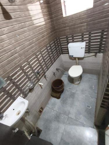 a bathroom with a toilet and a sink at Hotel shivalay in Dwarka