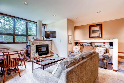 a living room with a couch and a fireplace at The Forest Neighborhood by Keystone Resort in Keystone