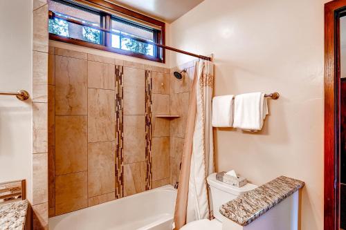 a bathroom with a shower and a toilet at The Forest Neighborhood by Keystone Resort in Keystone