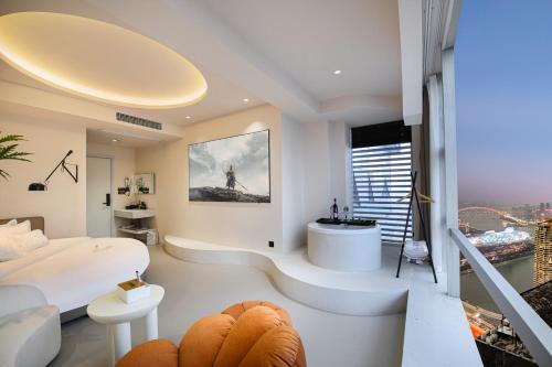 a white room with a bed and a balcony at Liberation Monument Riverside HoteL in Nan'an
