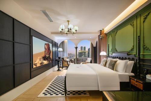 a bedroom with a large white bed and a desk at Liberation Monument Riverside HoteL in Nan'an
