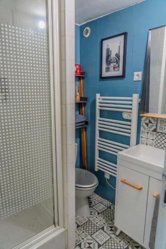 a blue bathroom with a toilet and a shower at L'Appart'Mans -charmant-studio-centre ville-2 pers in Le Mans
