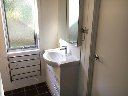 a bathroom with a sink and a mirror at One95 Family Beach House in Anglesea