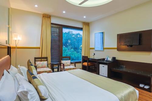 a hotel room with a bed and a television at Amber Inn by Orion Hotels in New Delhi