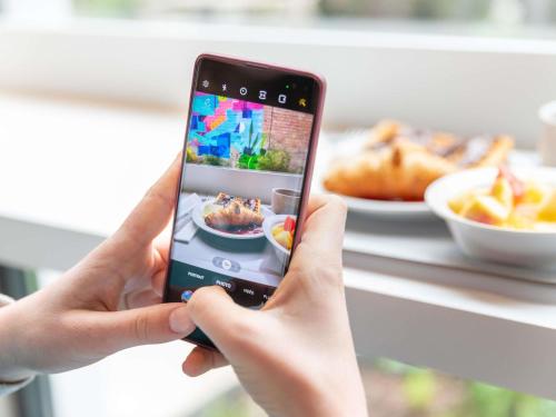 uma pessoa segurando um celular para tirar uma foto em Ibis Budget Strasbourg Centre Republique em Estrasburgo