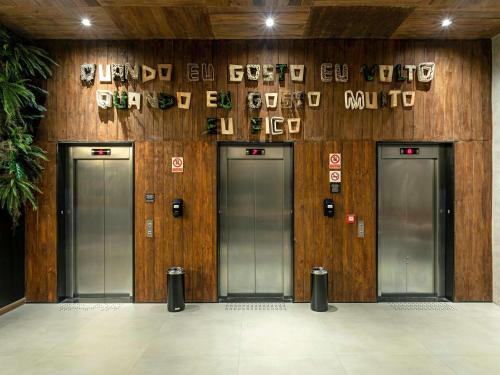 a row of four doors in a building at ibis Styles Maceió Pajuçara in Maceió