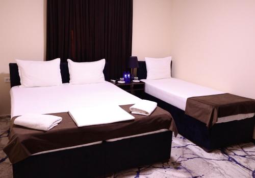 two beds sitting next to each other in a room at Al Bukhari Boutique Hotel in Bukhara