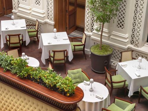 an overhead view of a restaurant with tables and chairs at Raffles London at The OWO in London
