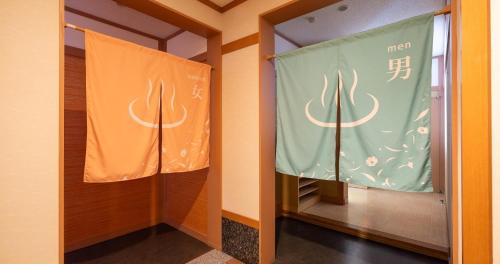 a hallway with two flags in a room at REBUN Hotel SARYO in Kafuka