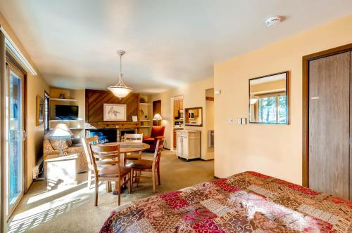 a bedroom with a bed and a table and chairs at The Forest Neighborhood by Keystone Resort in Keystone