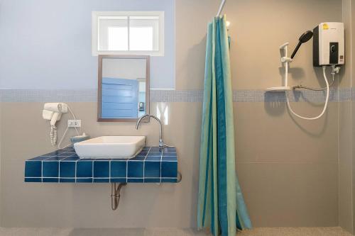 a bathroom with a sink and a shower at Doi Tung View Resort in Mae Sai
